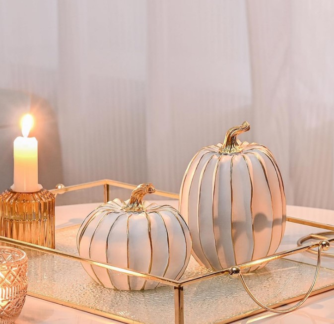 white and gold pumpkins on glass tray
