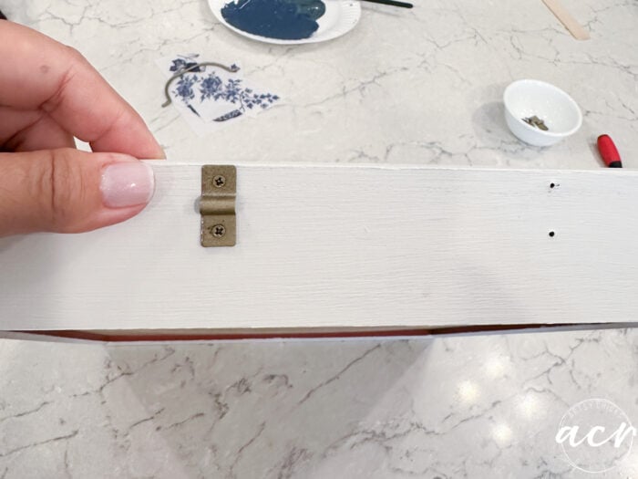 one gold hinge attached to tray