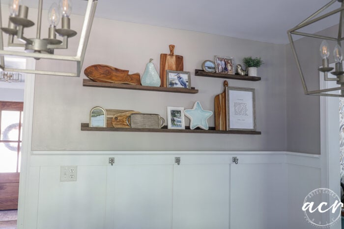 kitchen wall with various decor on narrow ledge style shelves