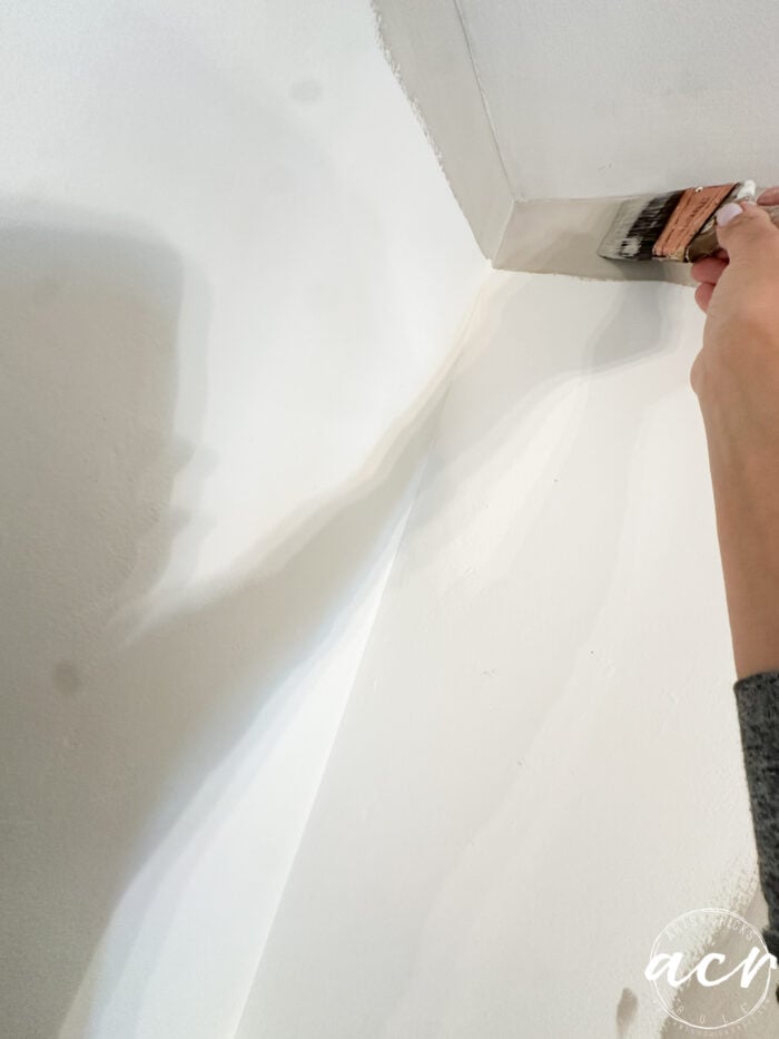 painting the kitchen wall with the new color anew gray