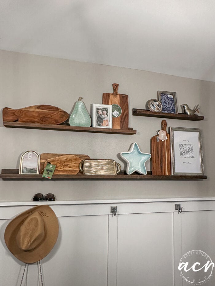 wood shelves decorated with hat hanging below