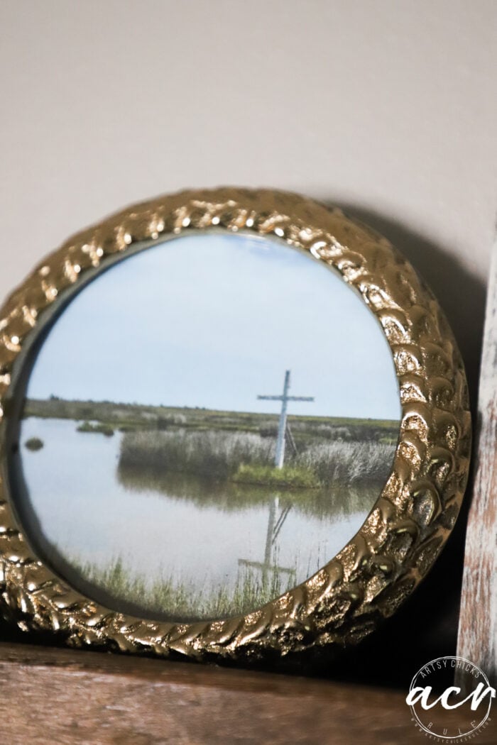 a cross in the marsh on the water