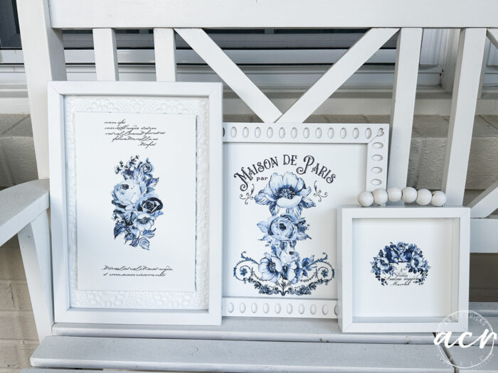 3 blue and white framed art on white bench