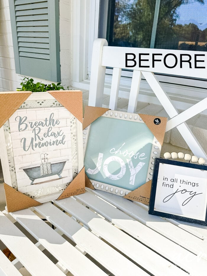 3 small pieces of framed word art on bench