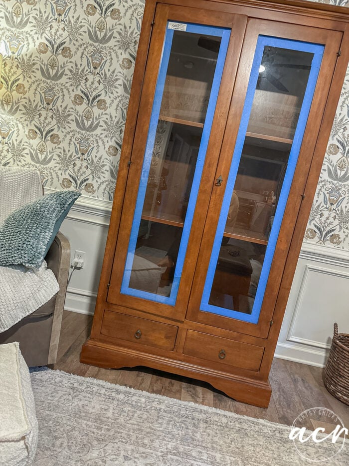 cabinet taped up around glass