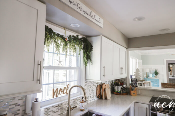 kitchen counter, window, cabinets with holiday decor