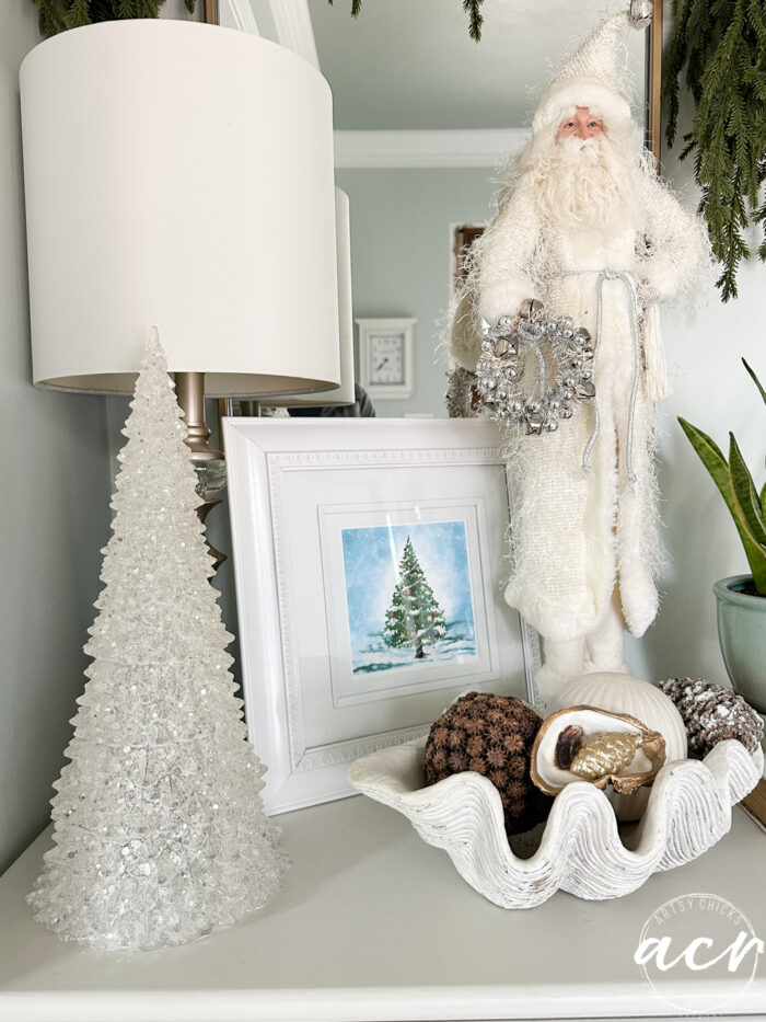tall all white clothed santa with christmas tree and framed white tree print
