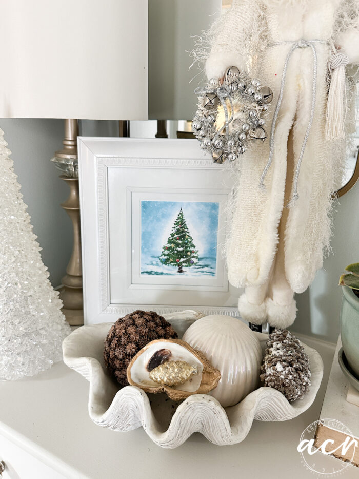 christmas tree print framed with other christmas decor and tall white clothed (not red) santa