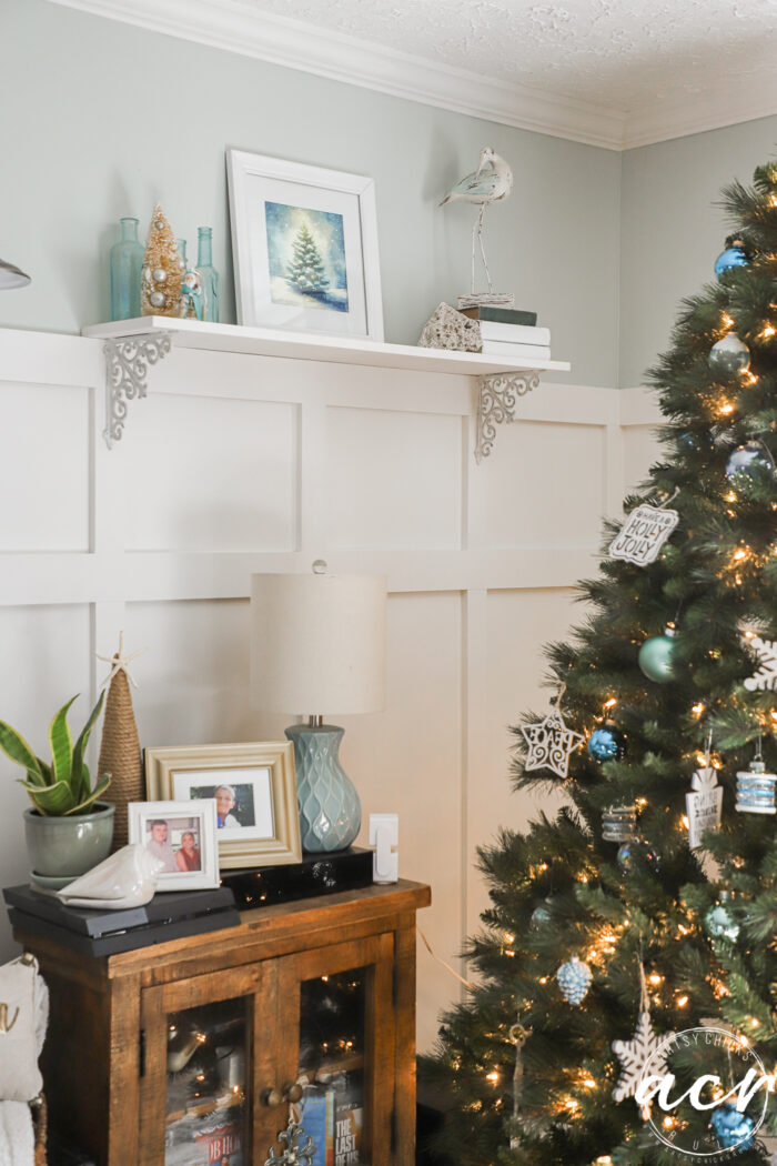 pretty new art on shelf by christmas tree