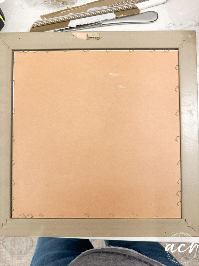 back of framed print with all the staples