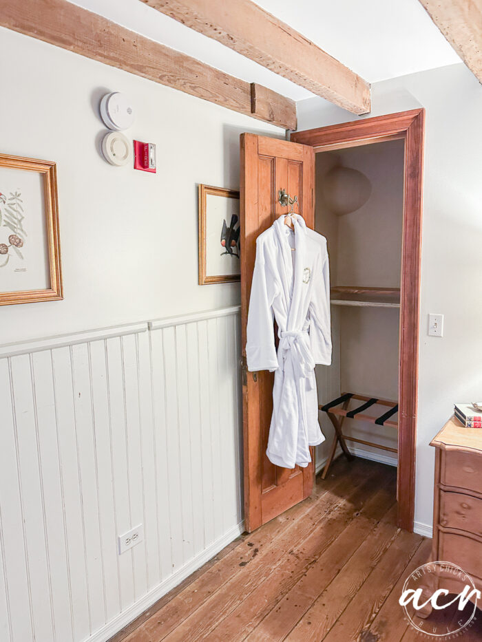 old wood door with white robes hanging