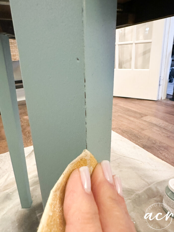 lightly sanding the edge of the table leg