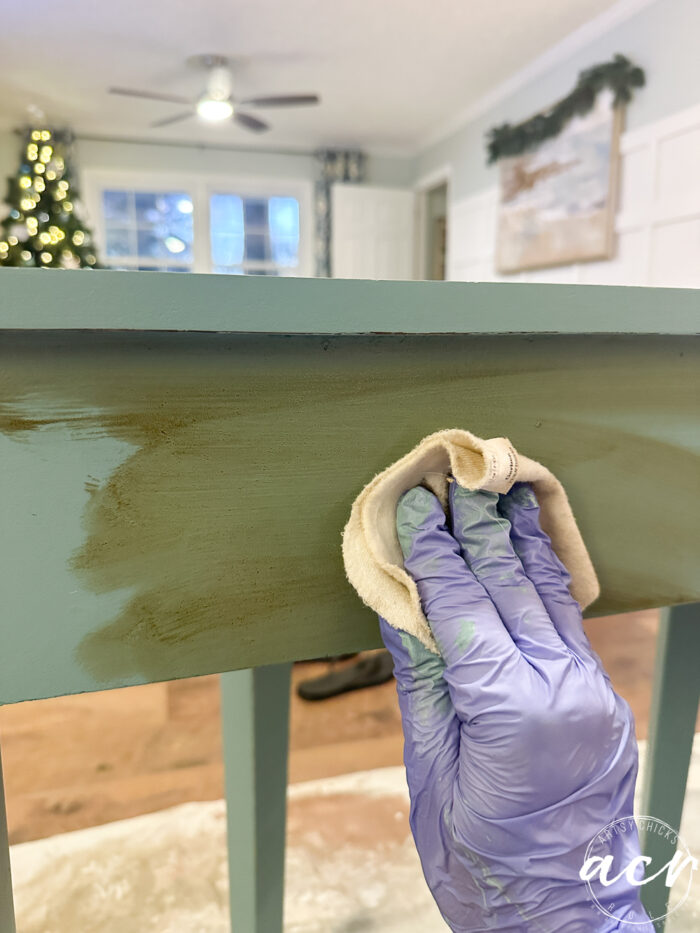 wiping stain onto the back of the table