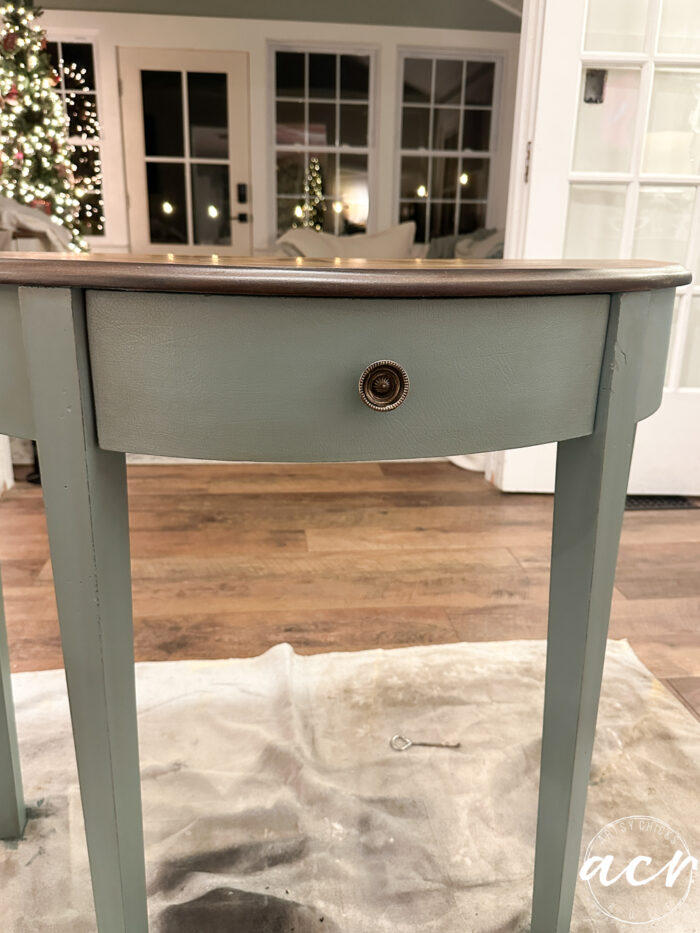 front of table stained with dark metal round knob