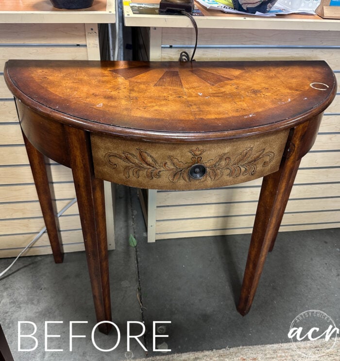 half moon table with design on front and inlays on top