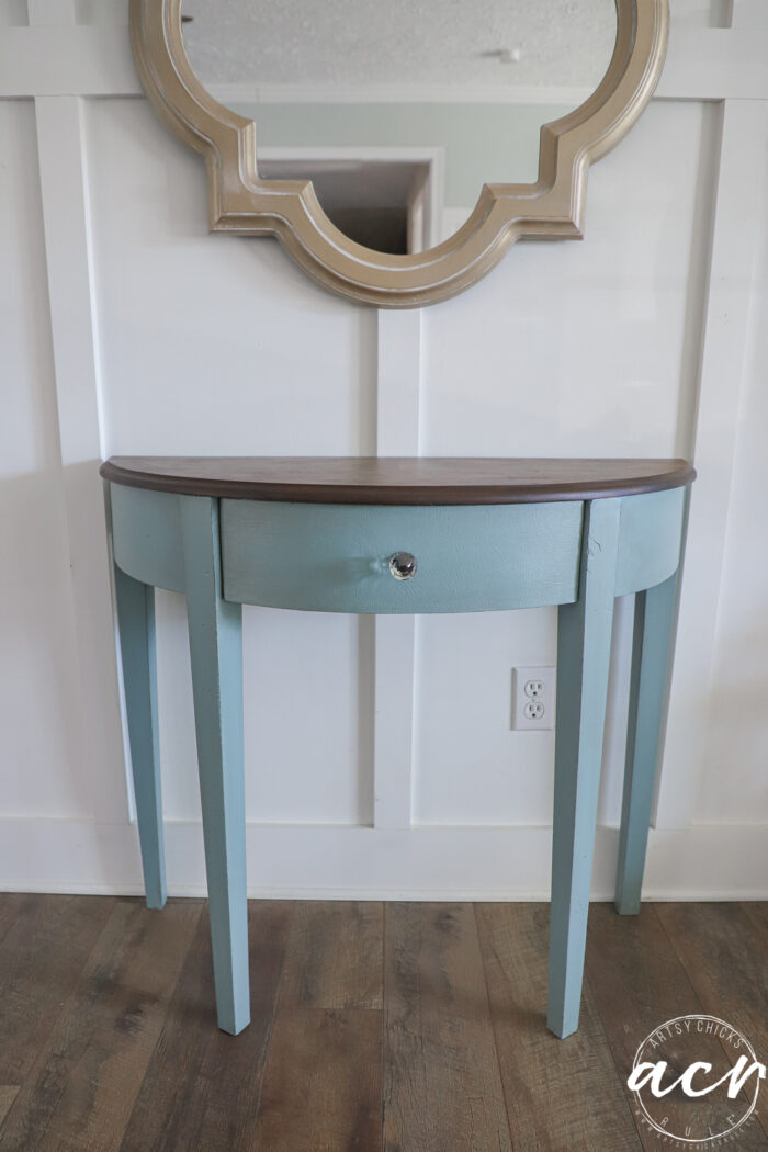 front view of blue table with stained top and crystal knob