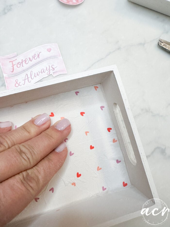 attaching napkin over top of transfer gel in bottom of box