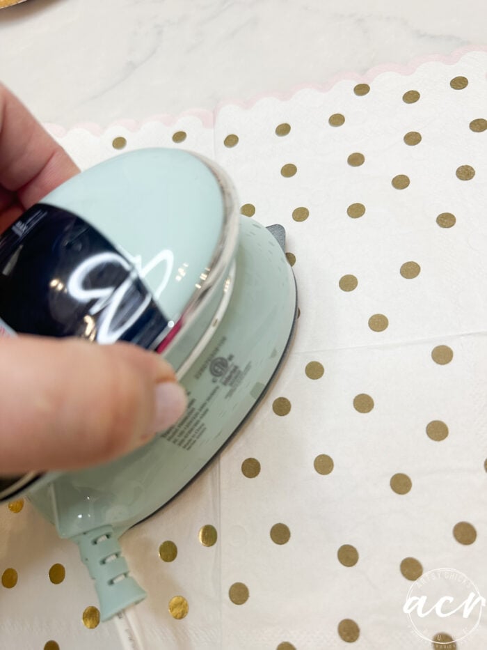 ironing the the creases out of the napkin