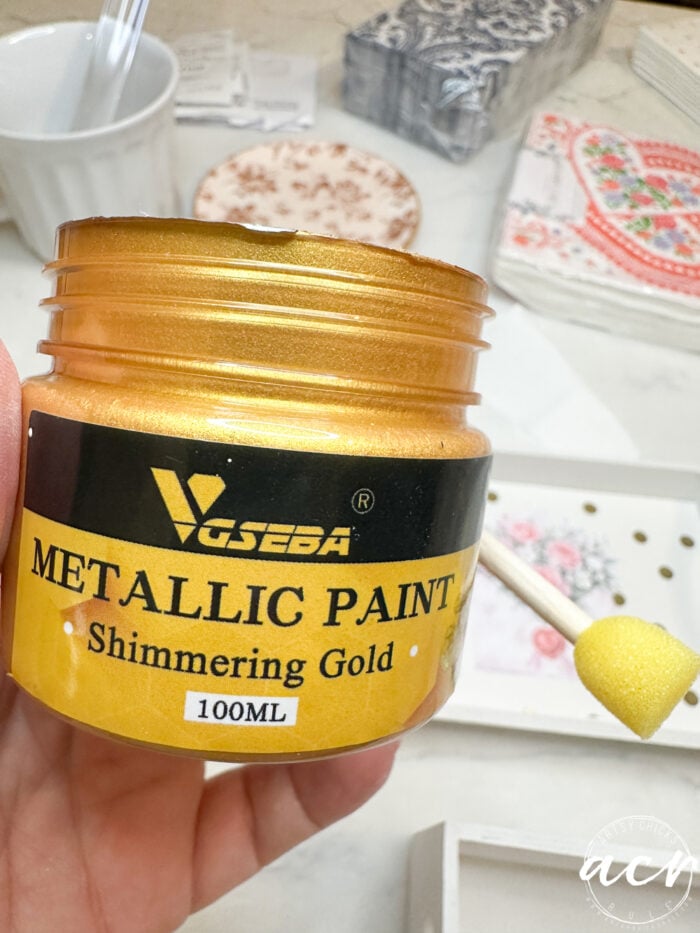 gold jar of paint with sponge applicator
