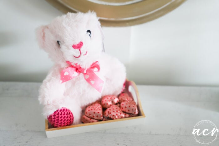pink bear in tray with pink hearts