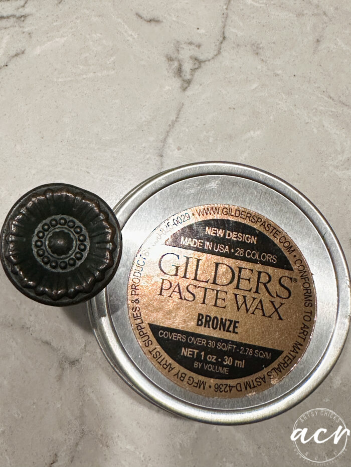bronze gilder's paste wax can and dark brown knob