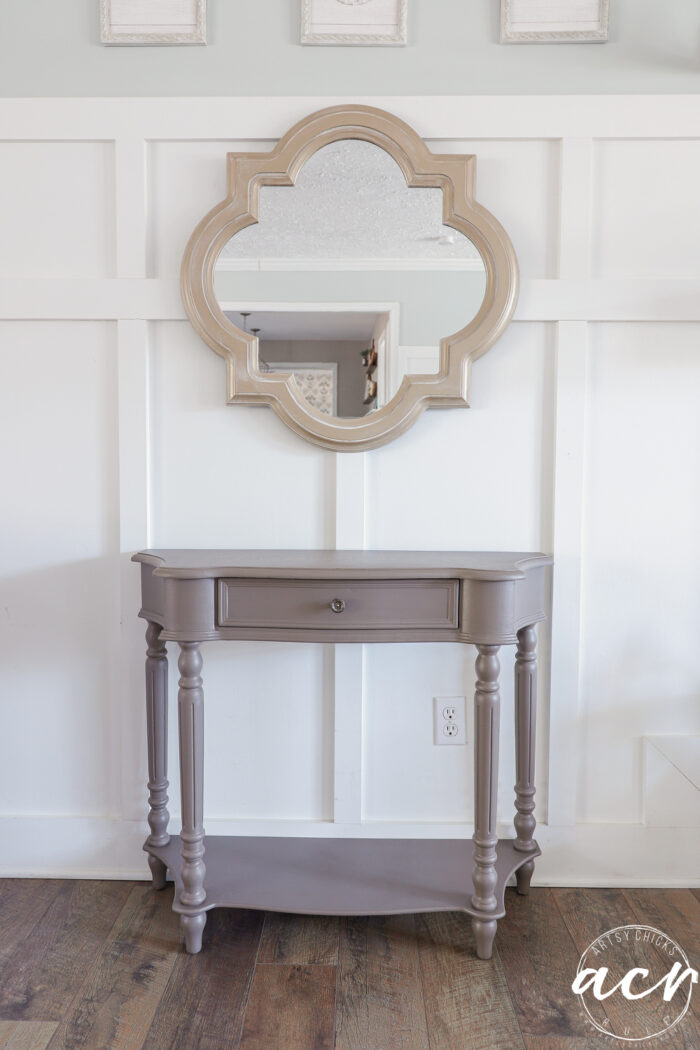 wood wick console with gold mirror above
