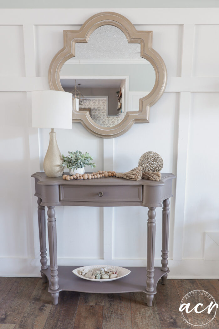 front view of table painted decorated with gold mirror above