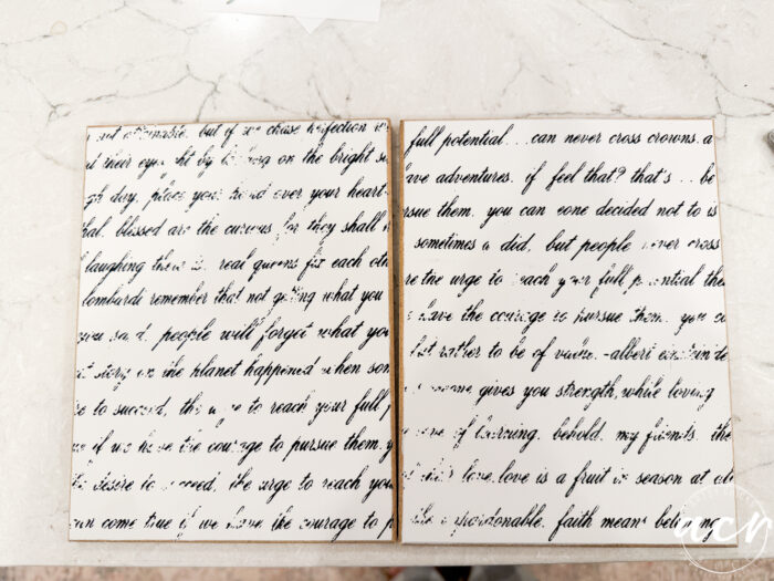 Two white boards are displayed side by side on a marble surface, each covered with cursive, black handwritten text. The text on this Easter Edition seems partially smudged or faded, making it difficult to read in full.
