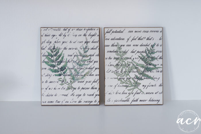 Two botanical wall art prints side by side, each featuring green fern illustrations overlaid on a background of cursive script, displayed on a plain white surface&mdash;a charming Easter Edition from Flipping Smalls.