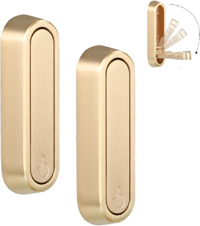 Two gold-colored wall-mounted holders with rounded edges, each featuring a subtle anchor symbol. A small inset shows the holder opening to reveal slots for organizing items like cotton swabs&mdash;one of my top Amazon Finds and Things I&rsquo;m Loving right now.