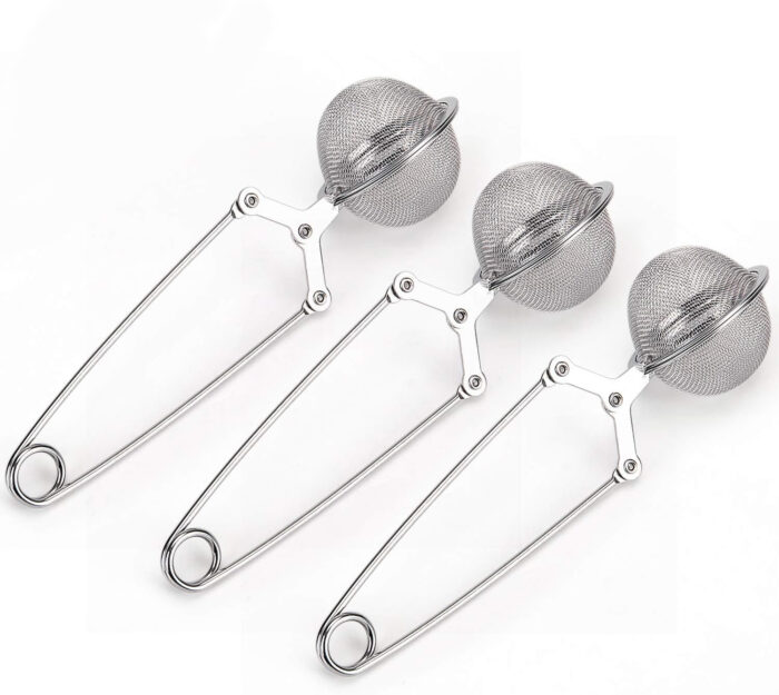Three stainless steel mesh tea infusers with long handles are arranged side by side on a white background&mdash;definitely among the things I&rsquo;m loving for easy, flavorful tea. Each infuser has a round mesh ball at the top for holding tea leaves.