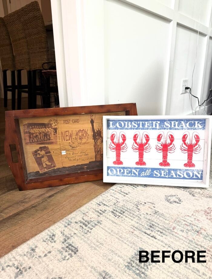 A wooden tray from a thrift shop, featuring a vintage New York postcard design and a framed &ldquo;Lobster Shack Open all Season&rdquo; sign with red lobsters, rests by a white wall. The word BEFORE appears in the bottom right corner.