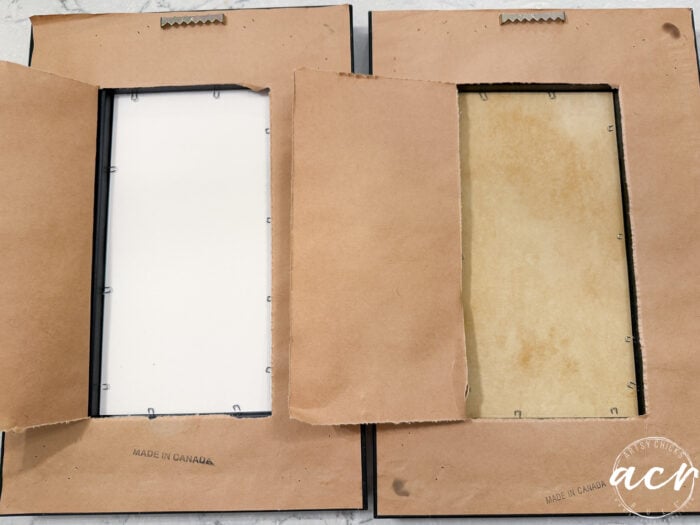 Two upcycled picture frames are shown from the back with brown paper backing partly torn open, exposing the backs and edges. Both have "Made in Canada" stamped at the bottom—a unique find for any framed print collection.