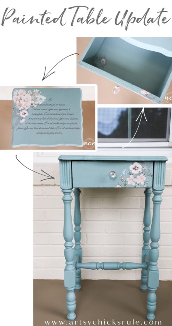 A small vintage end table painted teal with floral transfer accents, crystal knob, and decorative script inside the drawer. The table stands on turned legs and is displayed against a white brick wall.