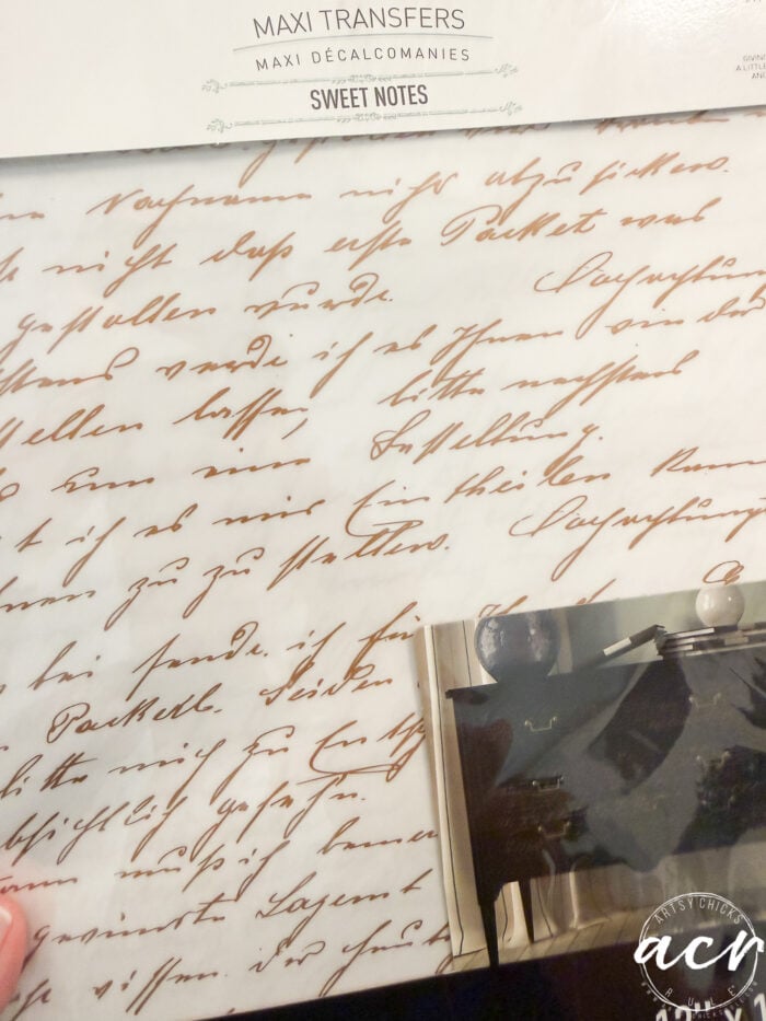 A package labeled “Maxi Transfers Sweet Notes” with a sheet featuring vintage cursive handwriting in brown ink—perfect for your next petite table or table makeover. A hand holds the package, and part of a black-and-white photo is visible at the bottom.