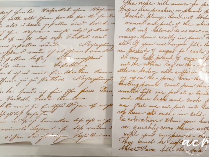 Two handwritten letters in brown ink on white paper, viewed at an angle atop a petite table; one letter is partially covered by a clear shiny sheet, creating reflections and making some words difficult to read—a charming detail for any furniture makeover.