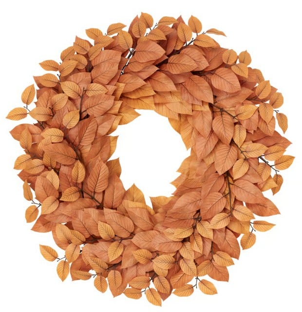 A wreath made of layered, overlapping brown and orange autumn leaves, arranged in a circular shape with a hollow center, against a white background—capturing the Best of Fall in every detail.