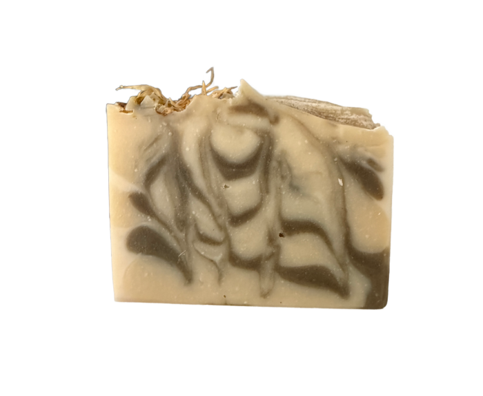 A beige handmade soap bar with dark brown swirls and dried herbs on top, displayed on a plain white background—one of our all natural fall soaps crafted to bring the essence of the season into your daily routine.