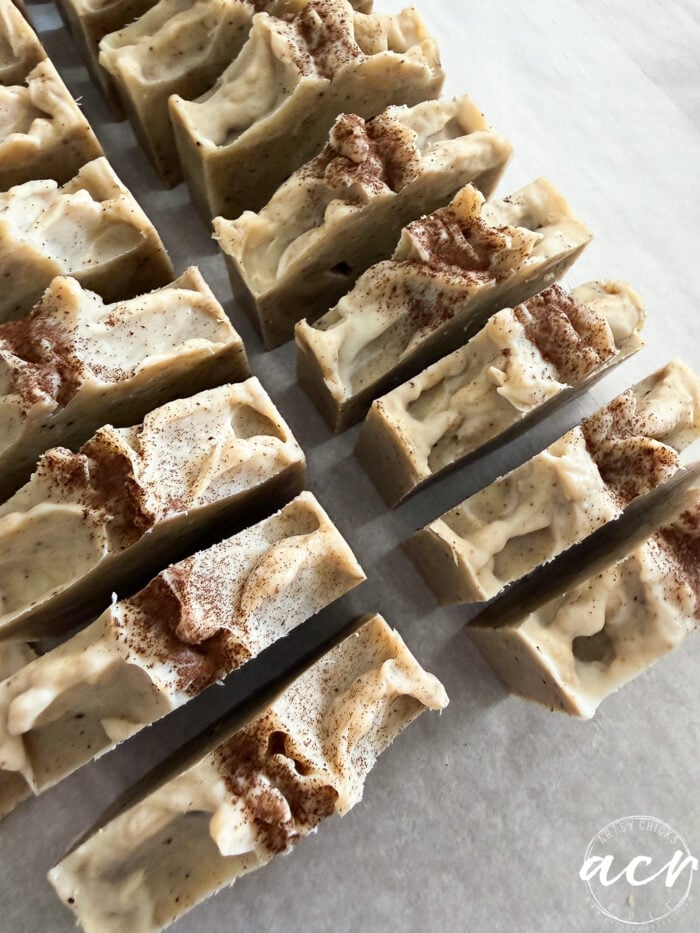 Handmade Fall Soaps with a textured, creamy surface sprinkled with brown powder, arranged in neat rows on a white surface. These all natural soaps are perfect for adding a touch of autumn to your daily routine.