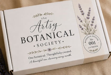 A white box labeled The Artsy Botanical Society with lavender illustrations and text stating Botanical Edition No. 001 Lavender and One botanical. Thoughtfully curated, this set features All Natural Soaps inspired by botanical ingredients, perfect for those who appreciate nature’s artistry.