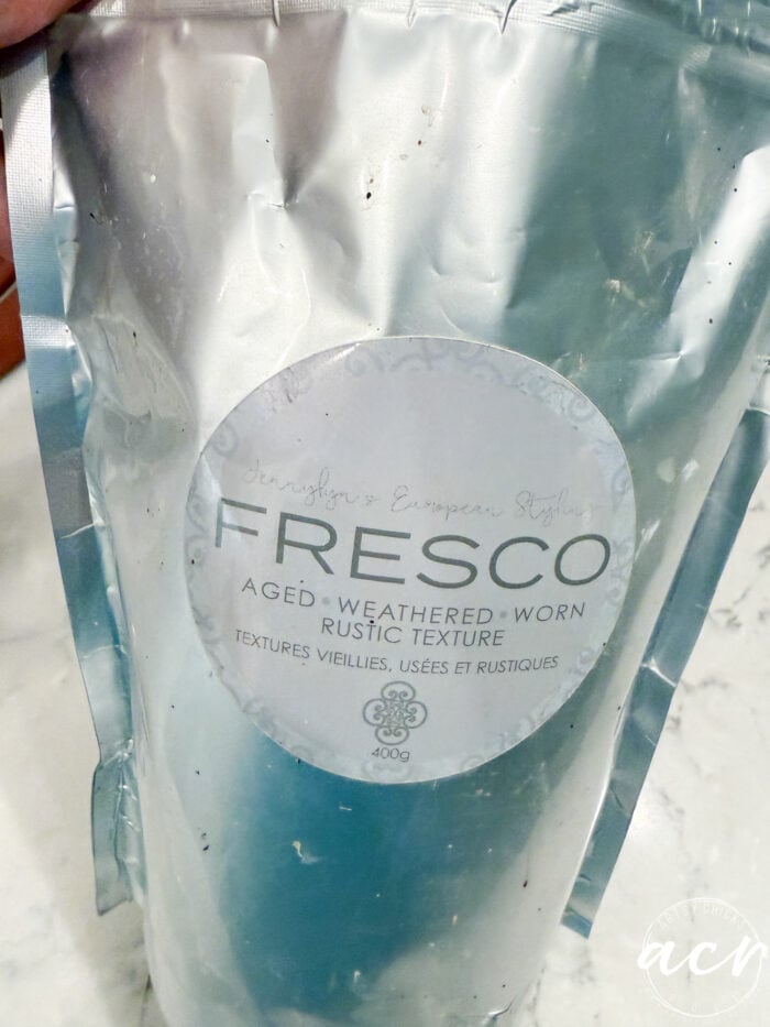 A 400g foil pouch of JenniLyns European Styling FRESCO aged, weathered, worn rustic texture paint for creating concrete decor.