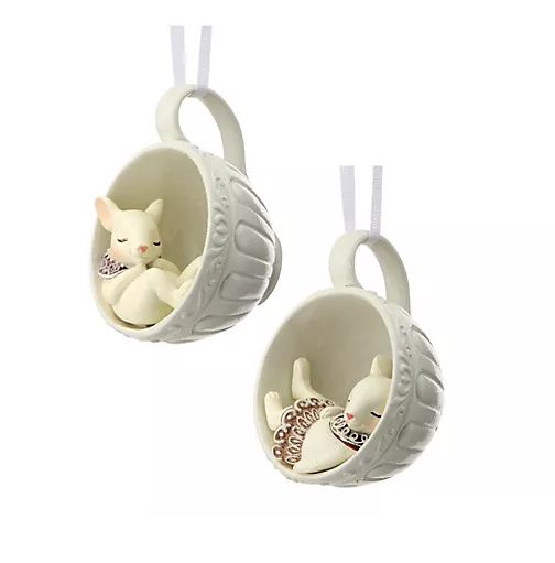 Two white ceramic teacup ornaments, each holding a small sleeping rabbit figurine, perfect for Christmas favorites.